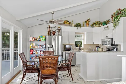 a view of a dining room with furniture a chandelier and wooden floor