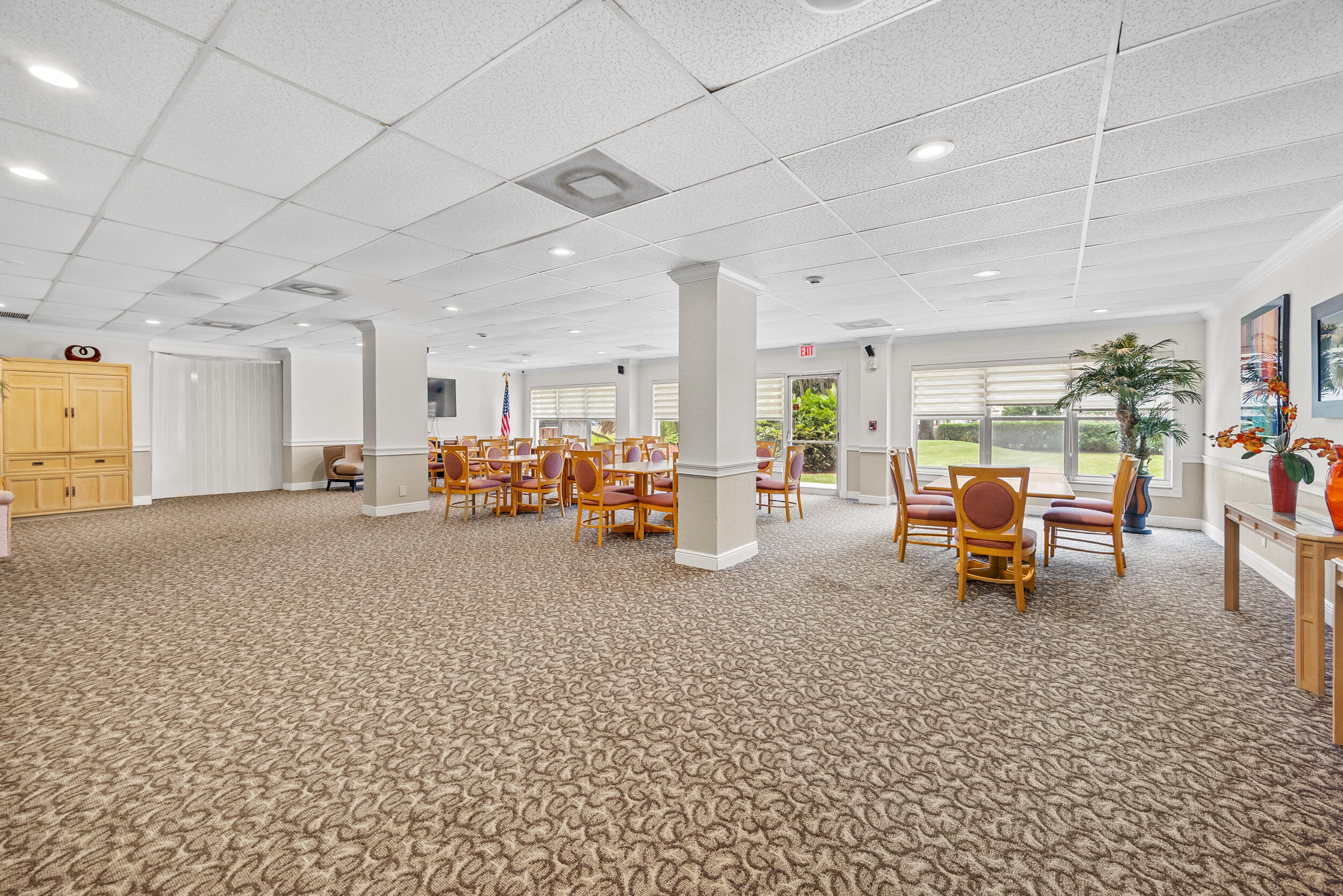 10777 West Sample Road, Unit 319 Coral Springs, FL 33065 - Photo 3 of 13 a living room with furniture and a table