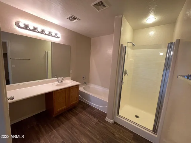 a bathroom with a bathtub a sink and a mirror