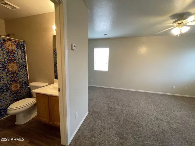 a bathroom with a toilet a sink and a mirror