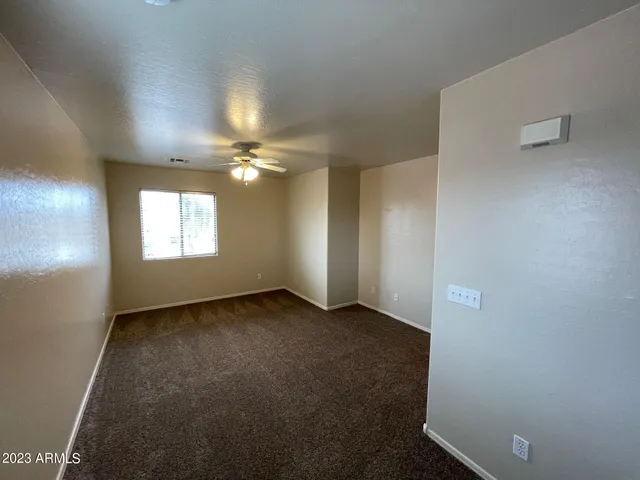 a view of an empty room and a window