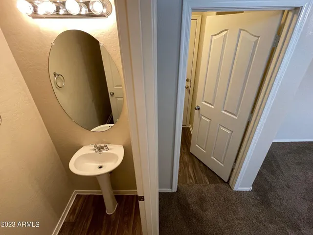 a view of bathroom with a sink and mirror