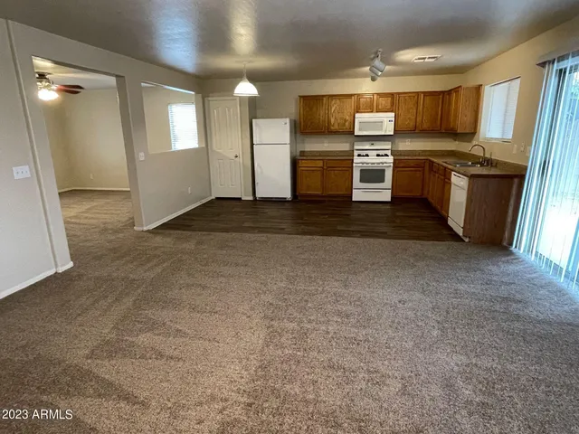 a kitchen with refrigerator and microwave