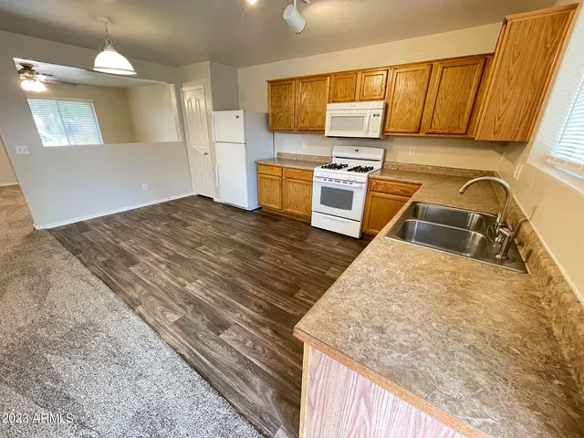 a kitchen with wooden floors and a sink