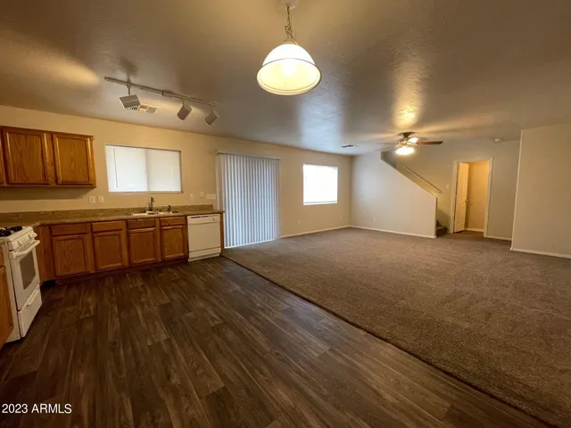 a large kitchen with kitchen island granite countertop a sink window and cabinets