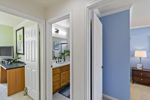 a view of a hallway and a livingroom with furniture