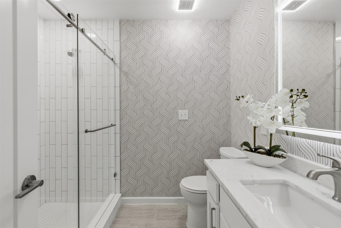 10902 Wareham Court Austin, TX 78739 - Photo 17 of 37 a bathroom with a sink a toilet and shower
