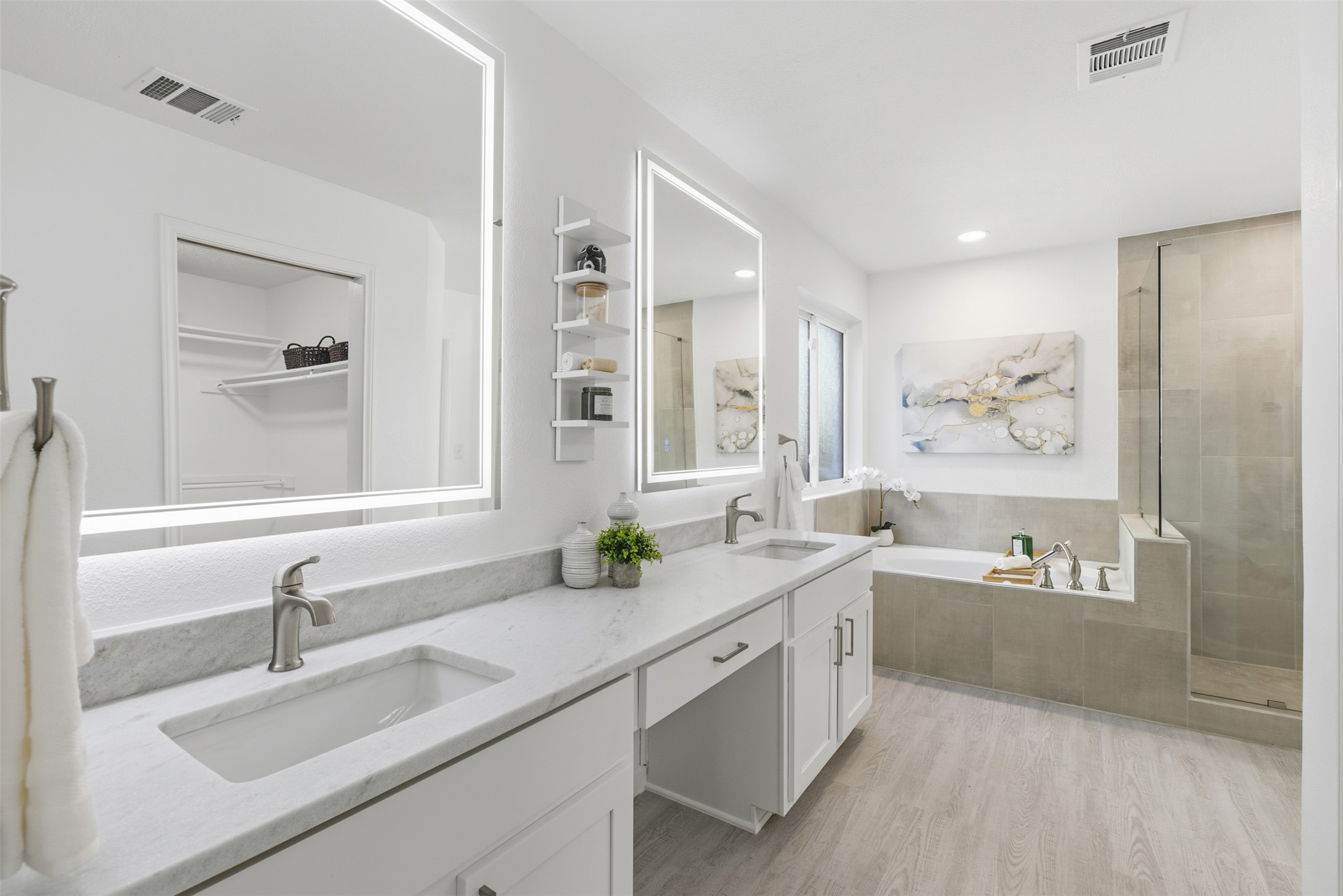 10902 Wareham Court Austin, TX 78739 - Photo 19 of 37 Full bathroom featuring light wood-style flooring, a garden tub, double vanity, a walk in closet, and a tile shower