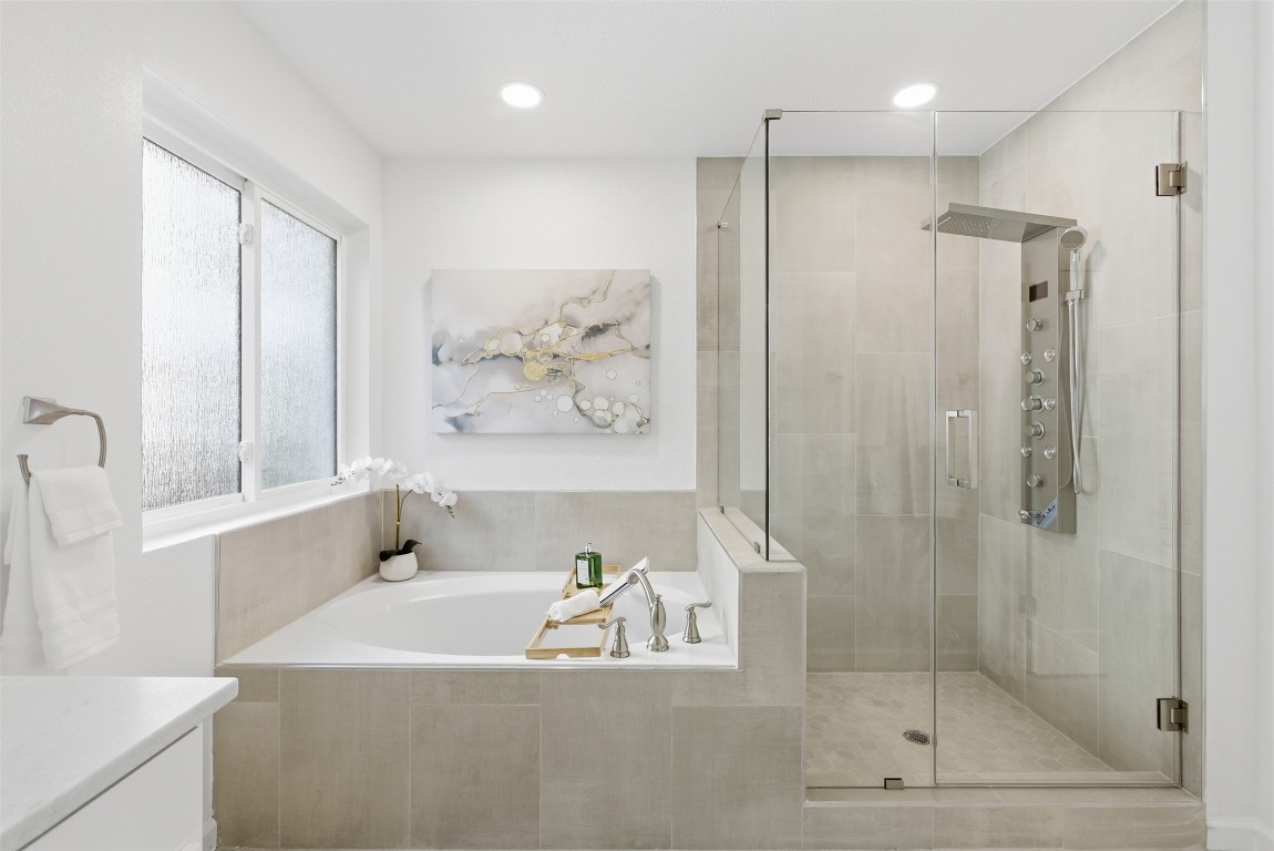 10902 Wareham Court Austin, TX 78739 - Photo 20 of 37 Bathroom featuring a garden tub, a stall shower, recessed lighting, and vanity