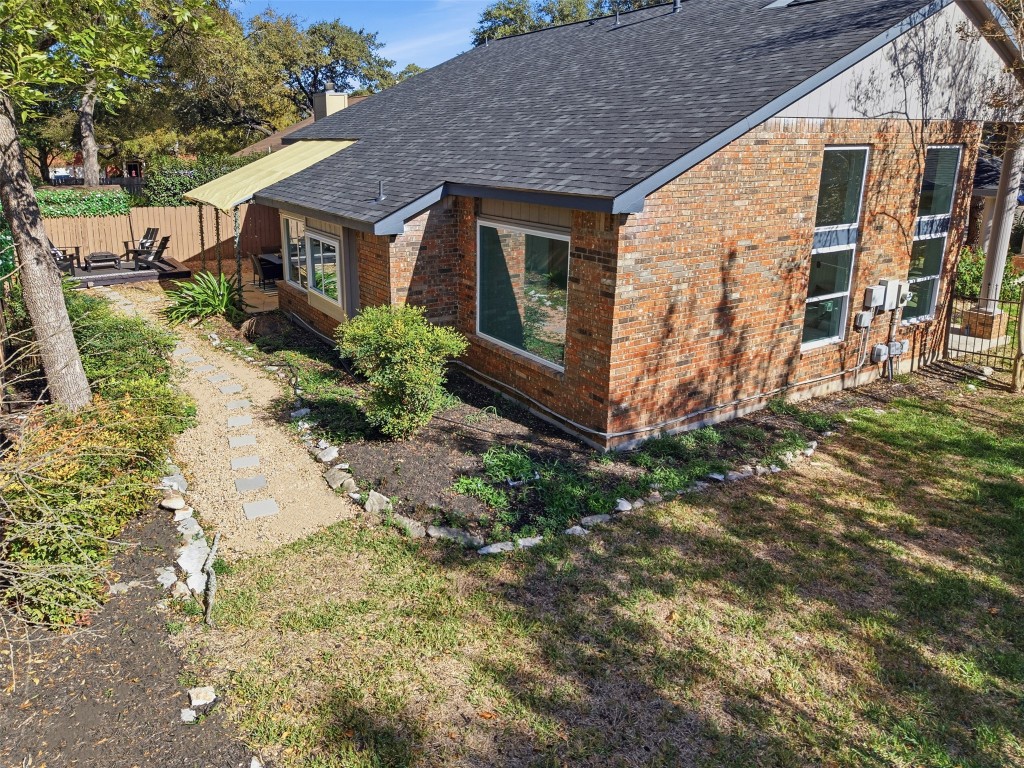 10902 Wareham Court Austin, TX 78739 - Photo 26 of 37 View of side of property with brick siding and roof with shingles