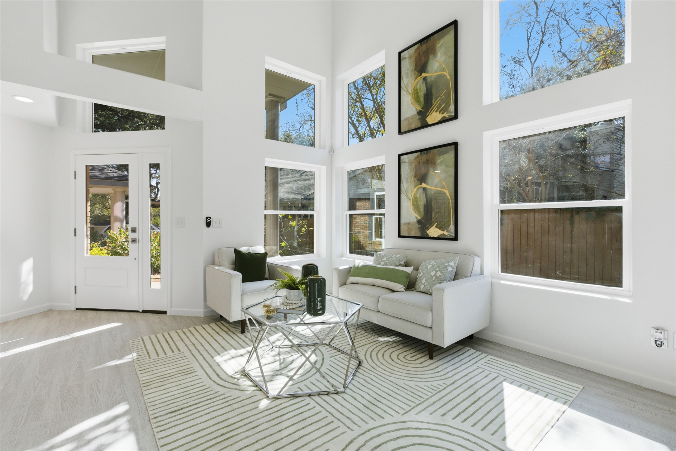 10902 Wareham Court Austin, TX 78739 - Photo 9 of 37 Living area with a towering ceiling, wood finished floors, and plenty of natural light