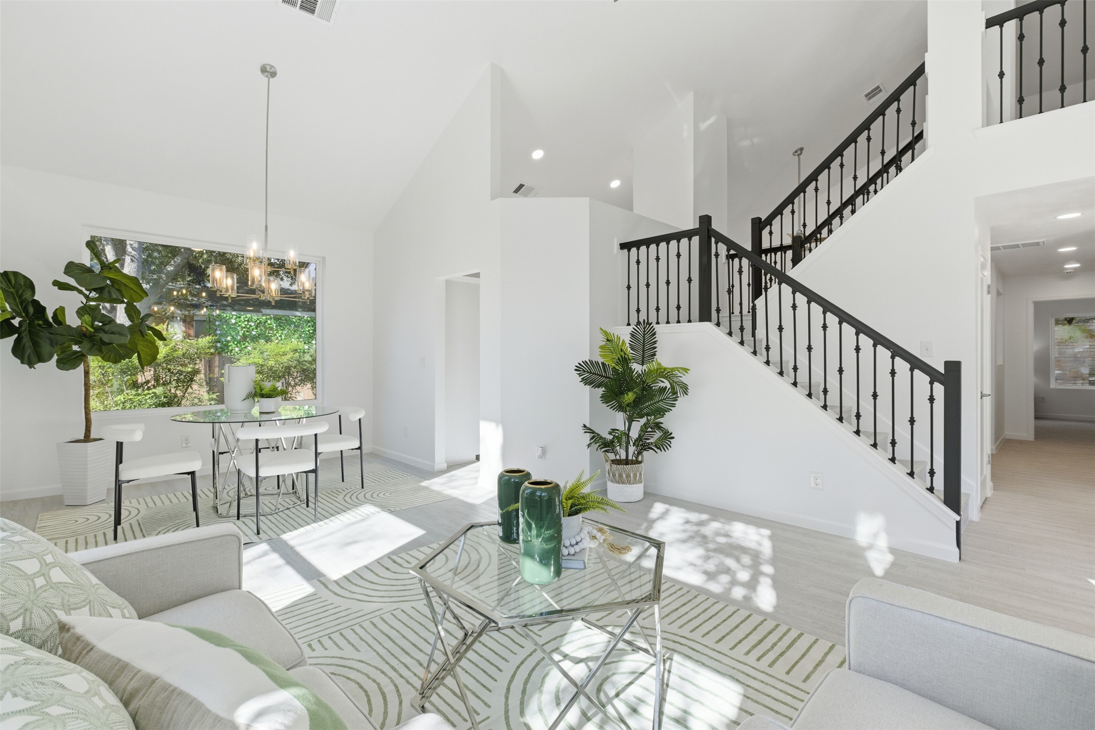 10902 Wareham Court Austin, TX 78739 - Photo 10 of 37 Living area featuring high vaulted ceiling, stairway, wood finished floors, and recessed lighting