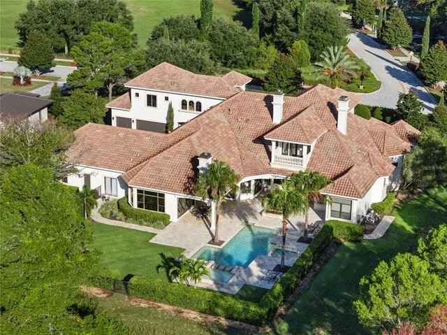 an aerial view of a house with a yard