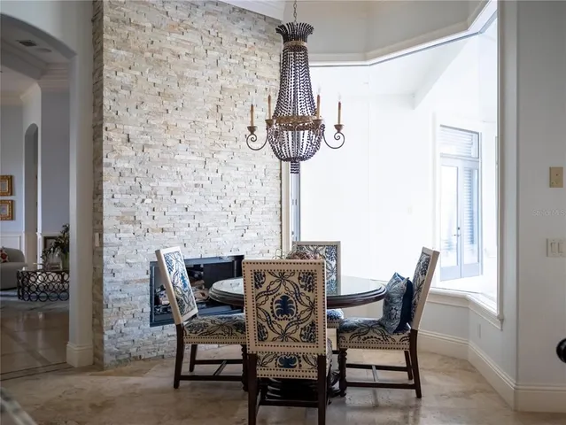 a view of a chandelier in a hall with wooden floor