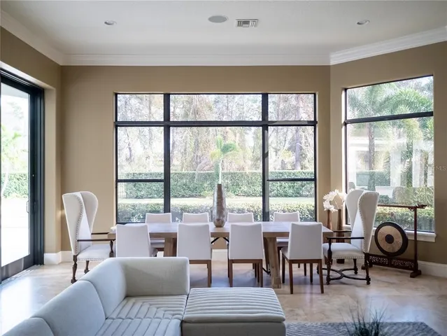 a bathroom with a sink mirror and a bathtub next to a window