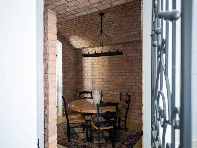 a living room with furniture and floor to ceiling windows