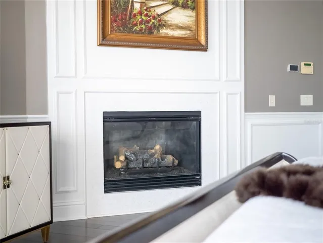 a utility room with stainless steel appliances granite countertop a sink a stove and a window