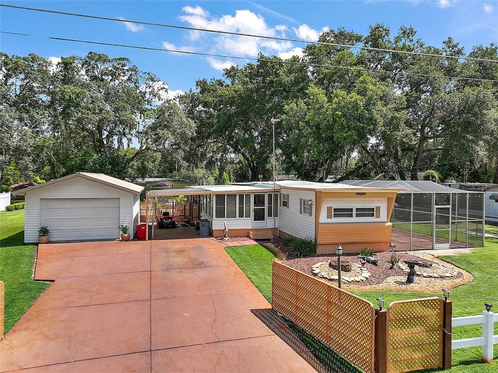 a view of a patio with couches table and chairs under an umbrella