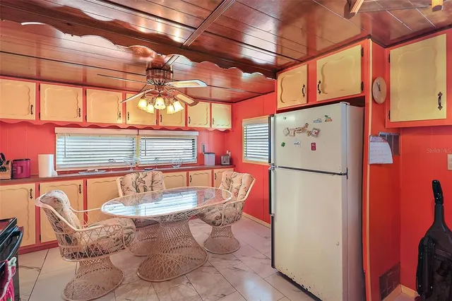 a kitchen with a refrigerator and table