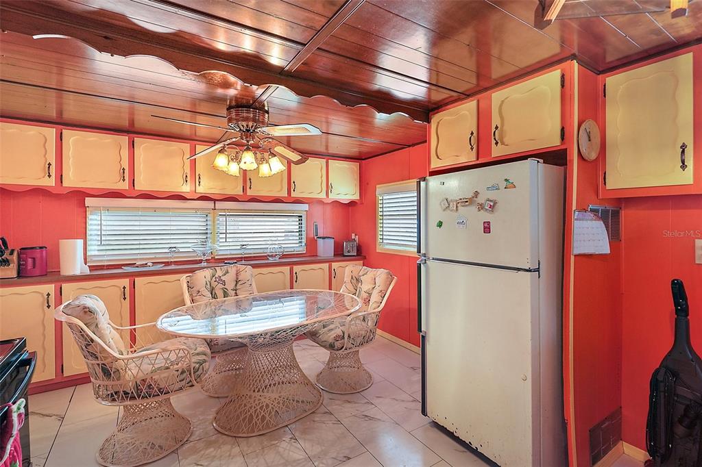 9935 Southeast 168th Place Summerfield, FL 34491 - Photo 15 of 25 a kitchen with a refrigerator and table