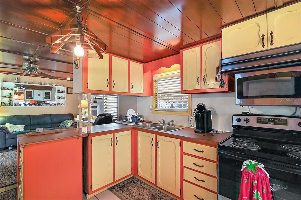9935 Southeast 168th Place Summerfield, FL 34491 - Photo 18 of 25 a kitchen with stainless steel appliances granite countertop a sink a stove and a microwave