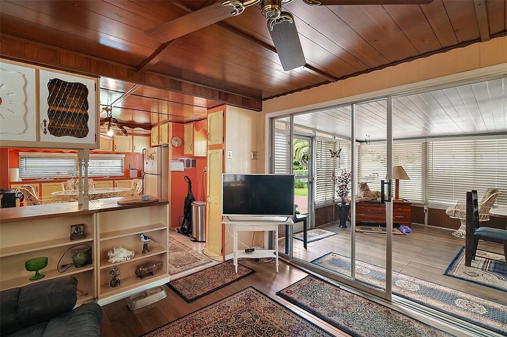 9935 Southeast 168th Place Summerfield, FL 34491 - Photo 19 of 25 a living room with a flat screen tv and a floor to ceiling window
