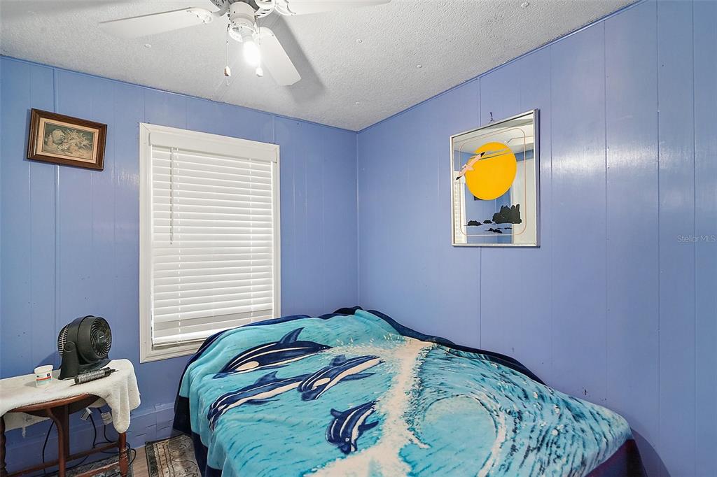 9935 Southeast 168th Place Summerfield, FL 34491 - Photo 23 of 25 a bedroom with a bed and painting on the wall
