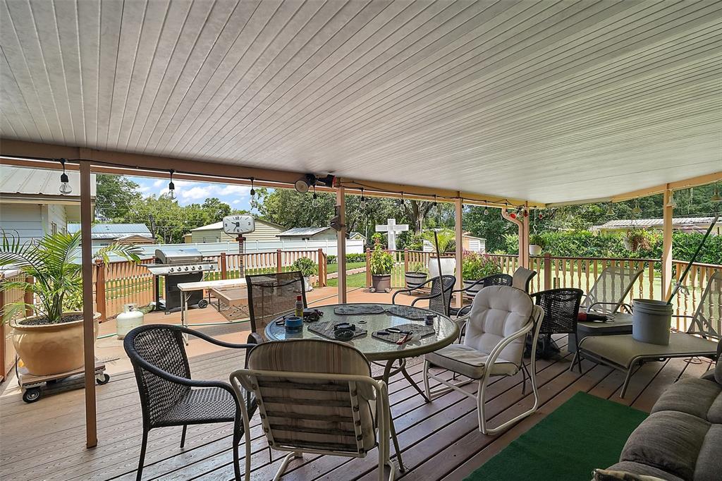 9935 Southeast 168th Place Summerfield, FL 34491 - Photo 3 of 25 a view of a patio with couches chairs dining table and chairs