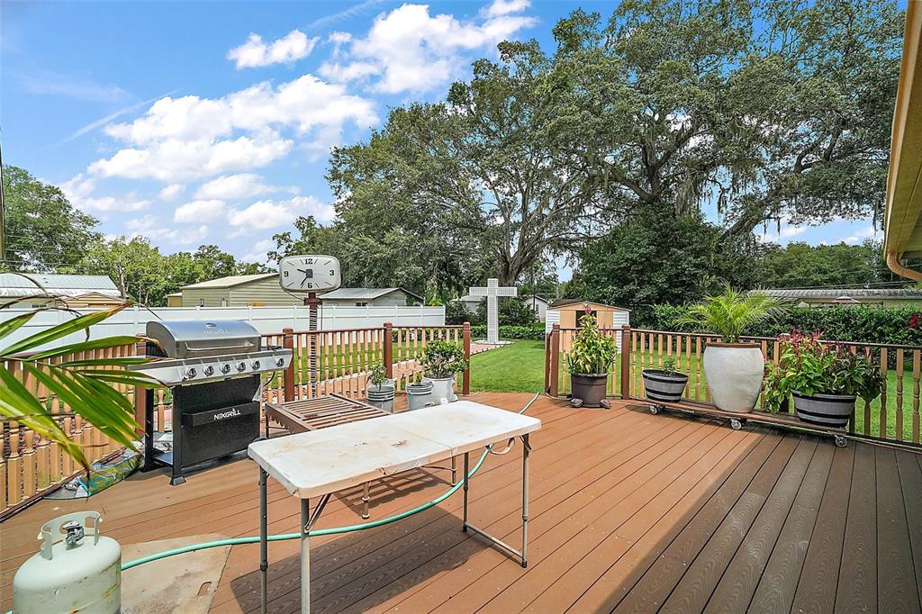 9935 Southeast 168th Place Summerfield, FL 34491 - Photo 5 of 25 a balcony with wooden floor table and chairs