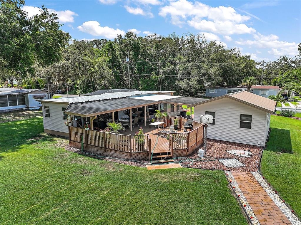 9935 Southeast 168th Place Summerfield, FL 34491 - Photo 7 of 25 a view of a patio with table and chairs under an umbrella
