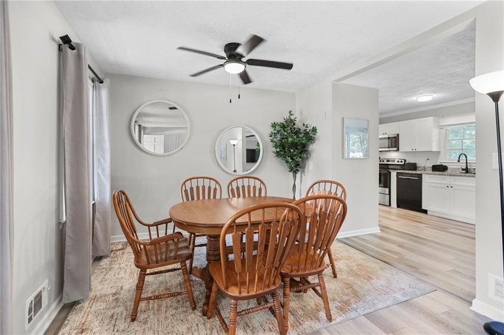 20 Carriage Trace Stockbridge, GA 30281 - Photo 12 of 35 a dining room with furniture a kitchen a chandelier and wooden floor