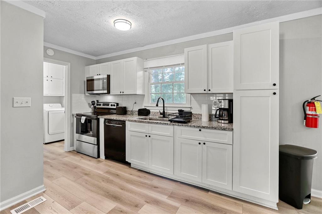 20 Carriage Trace Stockbridge, GA 30281 - Photo 13 of 35 a kitchen with white cabinets and appliances