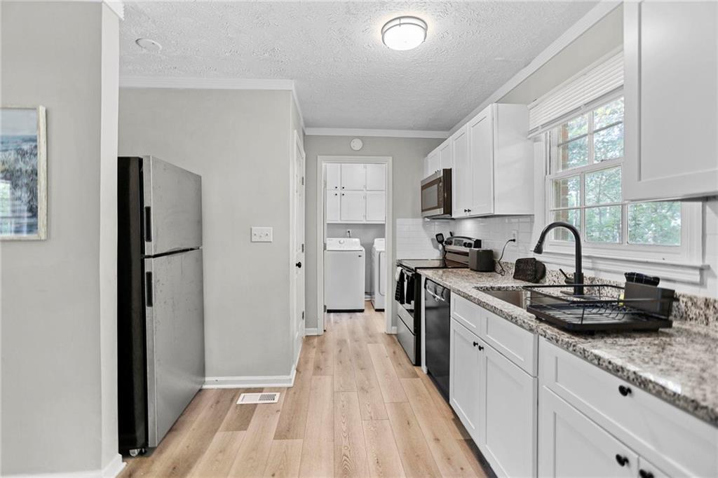 20 Carriage Trace Stockbridge, GA 30281 - Photo 14 of 35 a kitchen with sink a refrigerator and cabinets