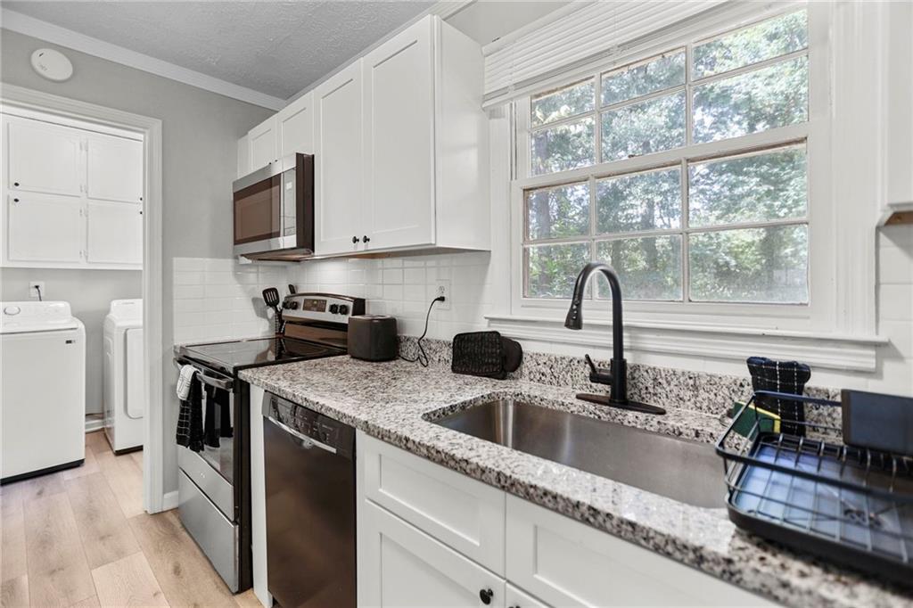 20 Carriage Trace Stockbridge, GA 30281 - Photo 15 of 35 a kitchen with stainless steel appliances granite countertop a sink and a stove