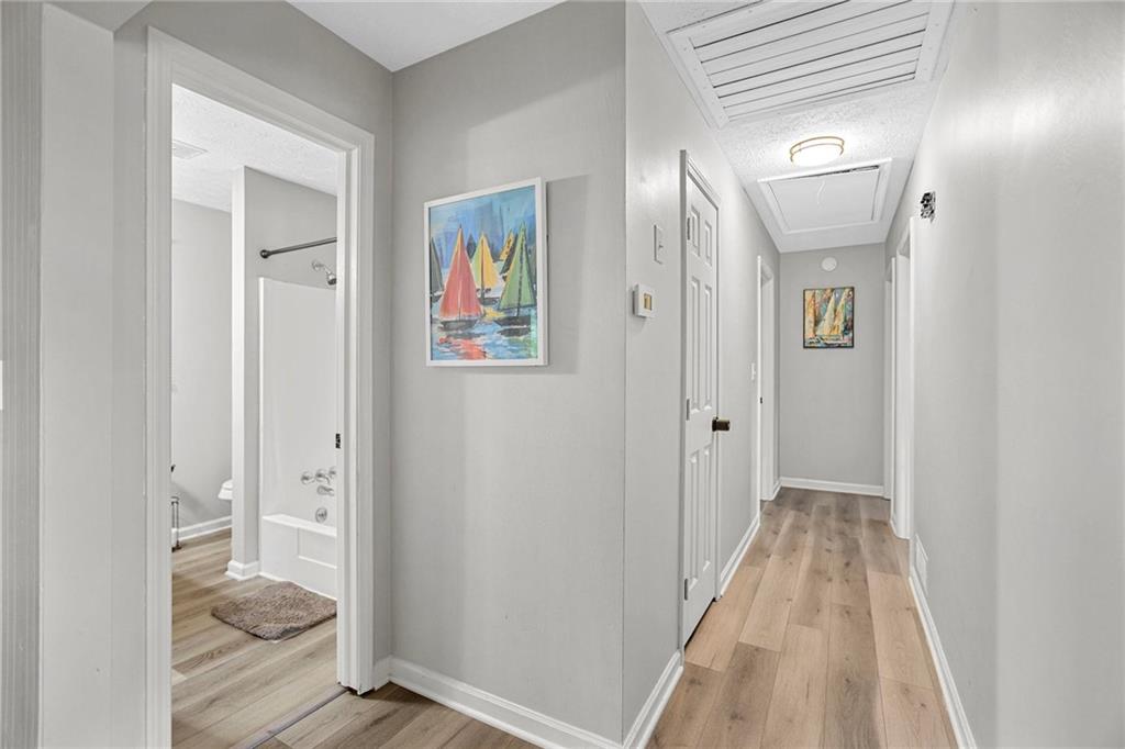 20 Carriage Trace Stockbridge, GA 30281 - Photo 20 of 35 a view of a hallway with wooden floor and a livingroom