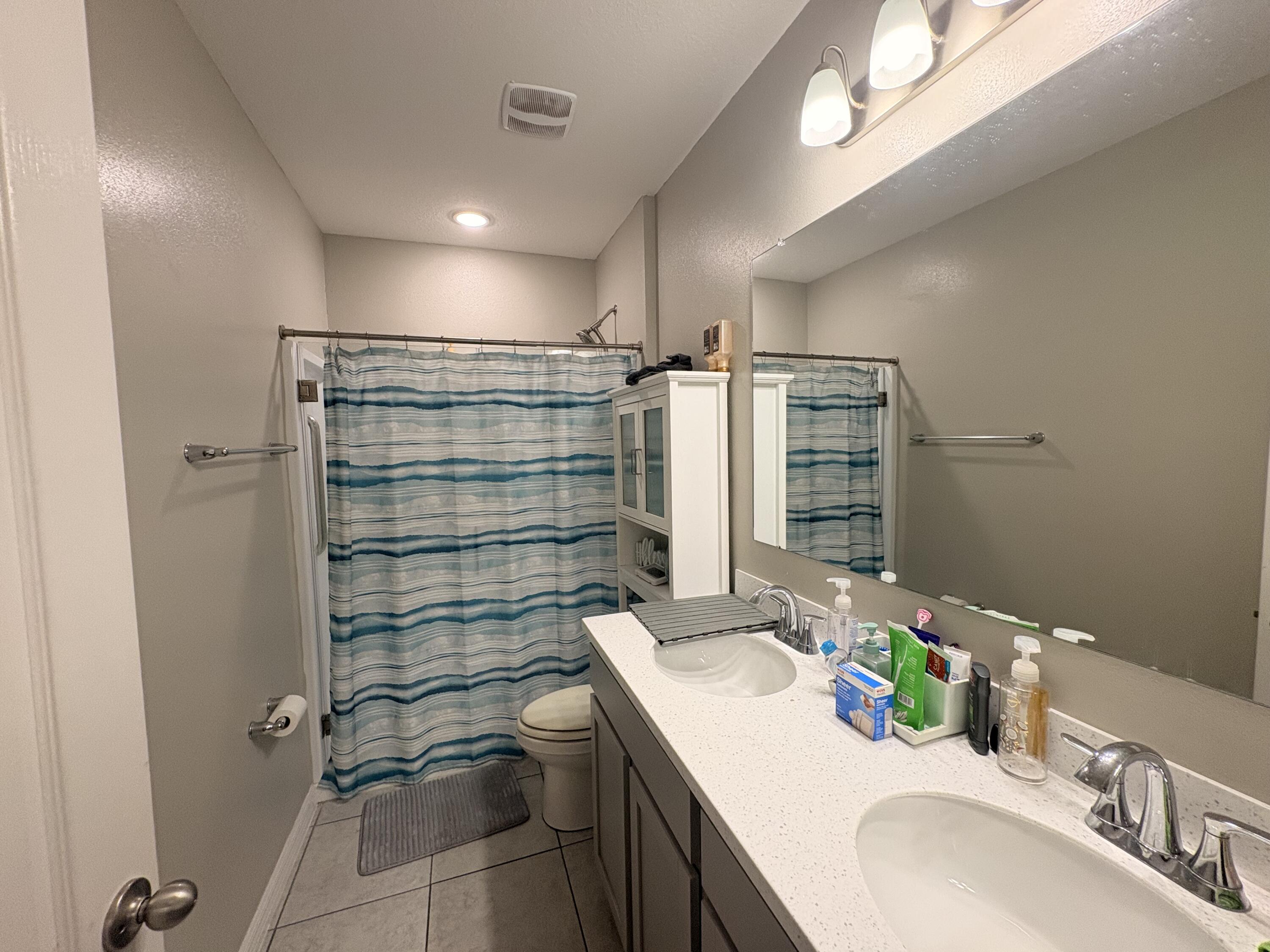9237 Swiss Road Spring Hill, FL 34606 - Photo 15 of 15 a bathroom with a sink shower vanity and a mirror