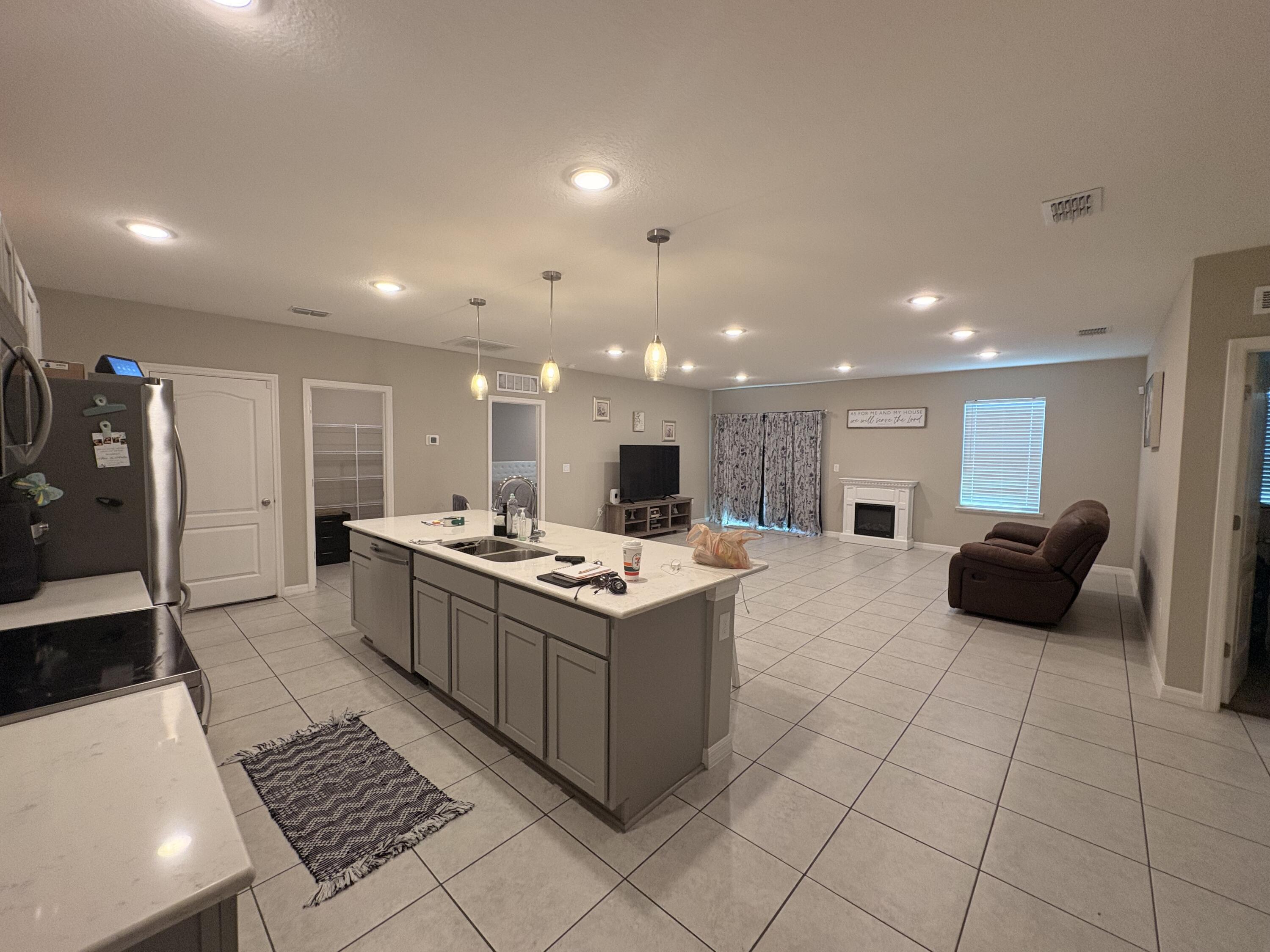 9237 Swiss Road Spring Hill, FL 34606 - Photo 4 of 15 a kitchen with a stove and a refrigerator