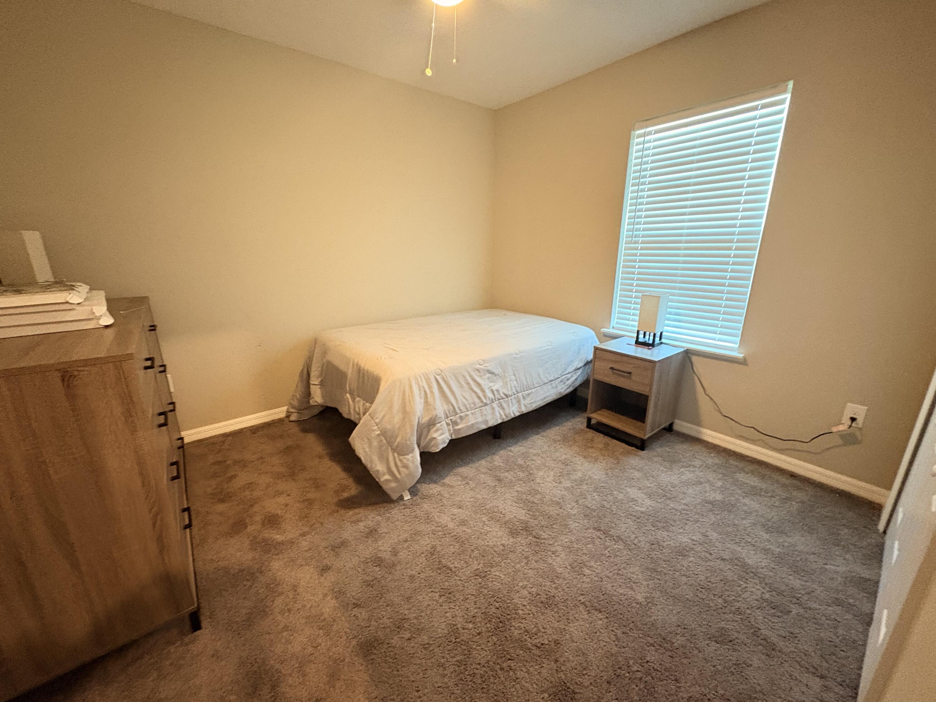 9237 Swiss Road Spring Hill, FL 34606 - Photo 8 of 15 a spacious bedroom with a bed and a window