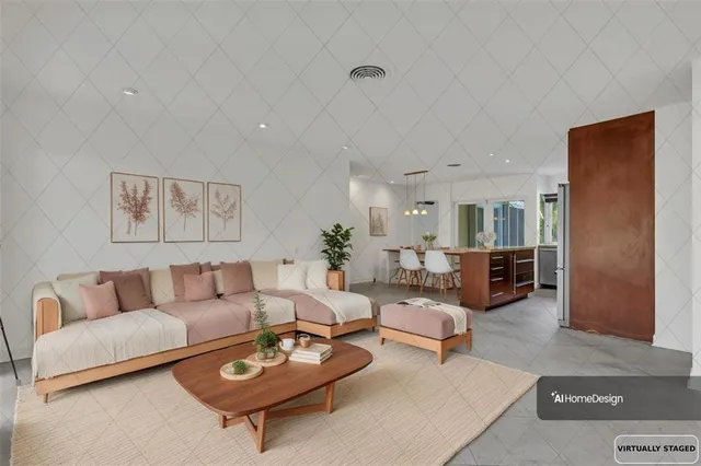 a living room with furniture a couch and kitchen view