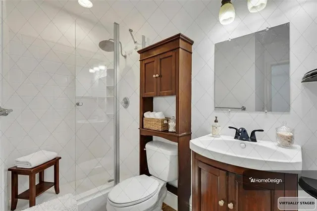a bathroom with a sink a toilet and shower