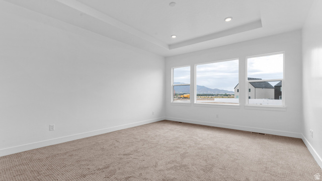 4170 North 560th West, Unit 6 Tooele, UT 84074 - Photo 9 of 20 Spacious interior room featuring a tray ceiling with recessed lighting