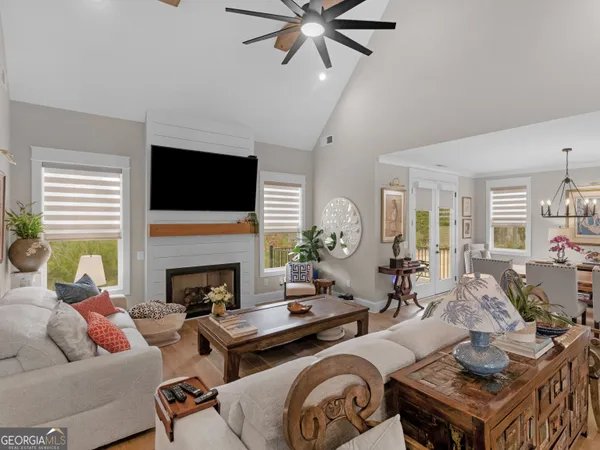 a living room with furniture a fireplace and a flat screen tv