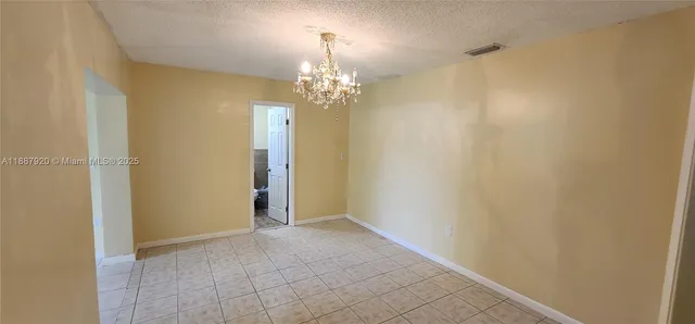 a view of a chandelier in big room and chandelier fan