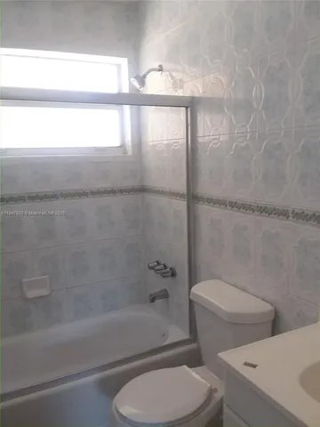 a bathroom with a toilet and a bathtub