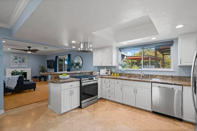 a kitchen with stainless steel appliances granite countertop a stove and a sink