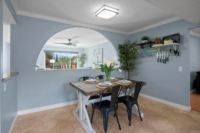a view of a dining room with furniture and a potted plant