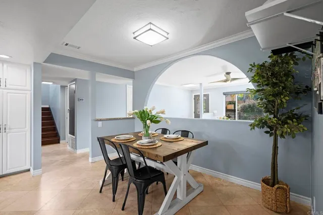 a view of a dining room with furniture and a potted plant