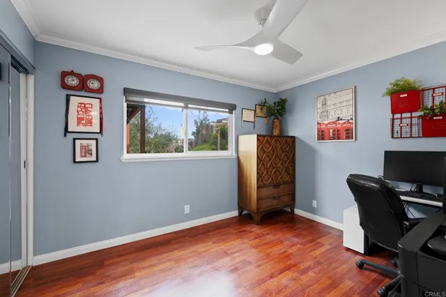 a view of a workspace with furniture and a window