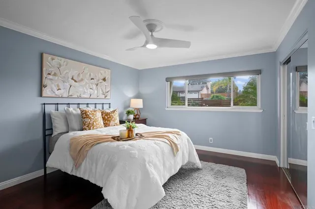 a bedroom with bed and wooden floor