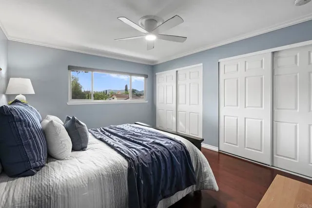 a bedroom with a bed and a painting on the wall